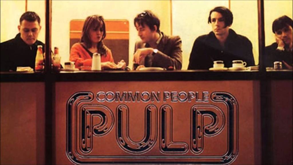 The members of Pulp seated in a diner window, doing what common people do.