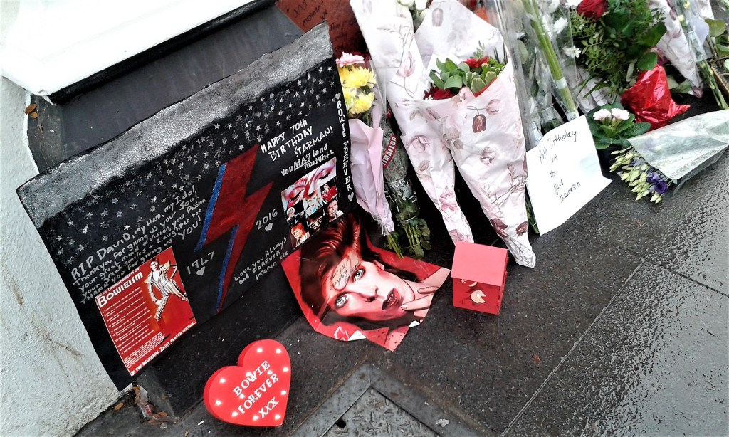 Birthday tributes laid at the David Bowie mural in Brixton, South London, on what would have been his 70th birthday.